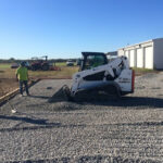 Grading rock for a slab at South Grand Lake Regional Airport.