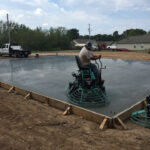 Finishing a slab for a metal building.